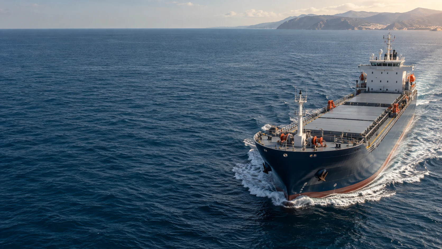 Illustrative cargo vessel underway on open blue water